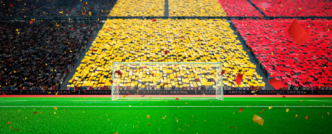 voetbalstadion gevuld met supporters die de kleuren van de Belgische vlag omhoog houden
